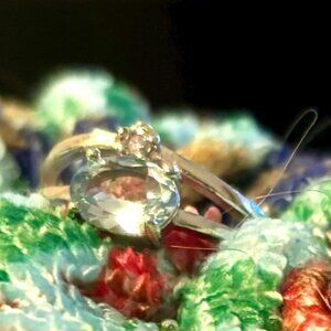 Light blue oval stone with small white crystal